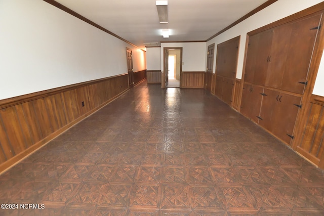 spare room featuring dark parquet floors and ornamental molding