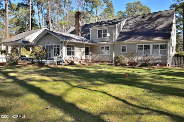 rear view of property with a yard