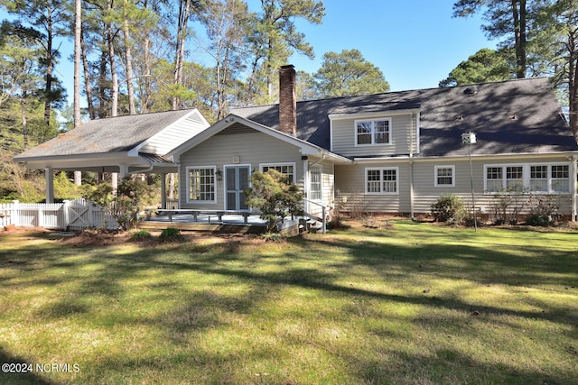 rear view of house featuring a yard