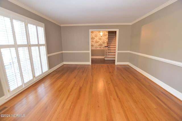 unfurnished room with dark hardwood / wood-style flooring, crown molding, and a healthy amount of sunlight