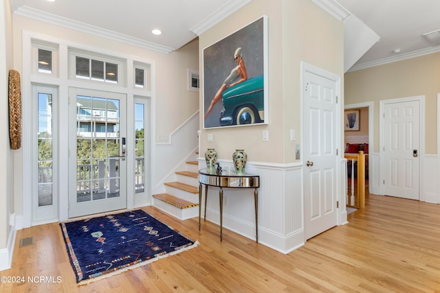 foyer entrance featuring light wood-type flooring and ornamental molding