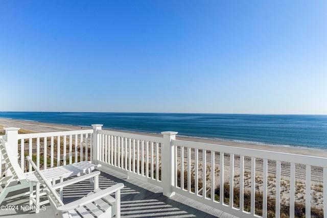 balcony featuring a water view and a view of the beach