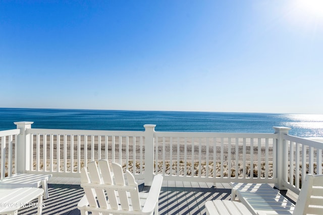 balcony featuring a water view and a view of the beach