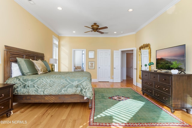 bedroom featuring ceiling fan, light wood-type flooring, and crown molding