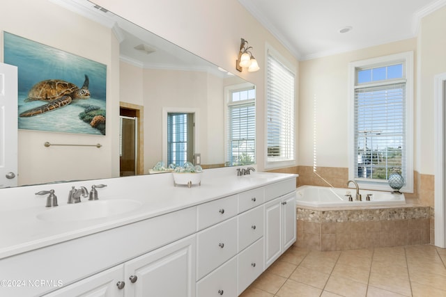 bathroom featuring vanity with extensive cabinet space, plenty of natural light, tile floors, and tiled tub