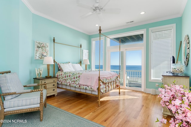 bedroom with a water view, light wood-type flooring, access to exterior, and crown molding