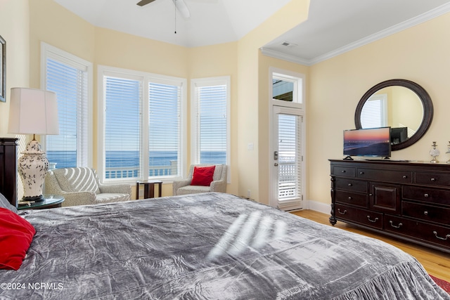 bedroom with ceiling fan, a water view, light hardwood / wood-style flooring, access to outside, and crown molding