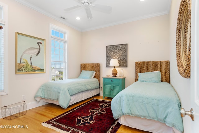 bedroom featuring light hardwood / wood-style floors, ceiling fan, and ornamental molding