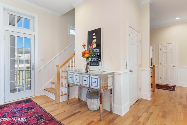 corridor featuring crown molding and light hardwood / wood-style flooring