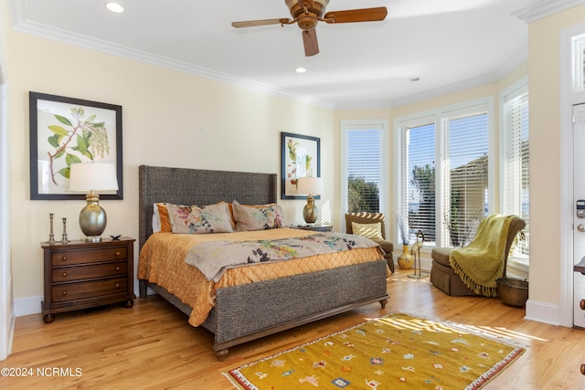 bedroom with ceiling fan, crown molding, and light wood-type flooring