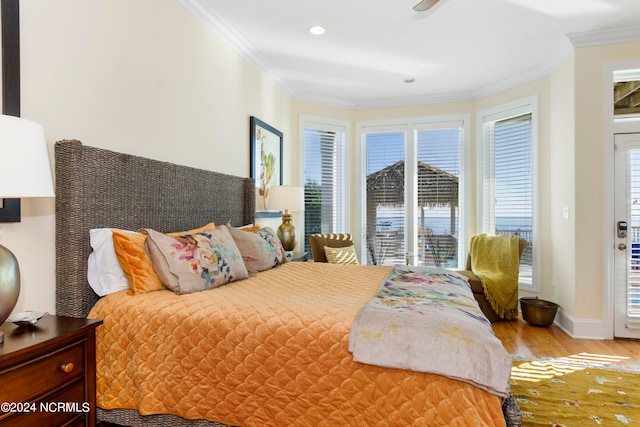 bedroom with multiple windows, crown molding, access to exterior, and light hardwood / wood-style floors