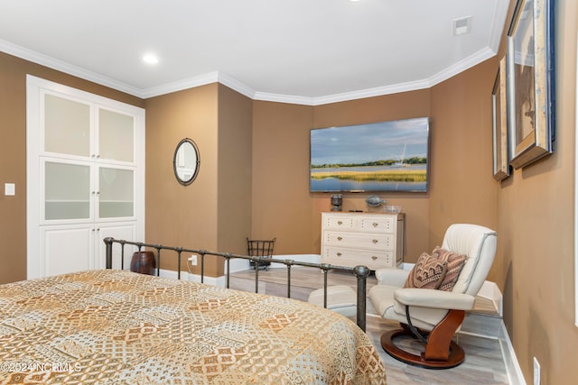 bedroom with wood-type flooring and ornamental molding