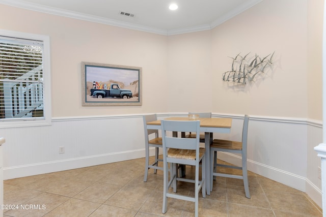 tiled dining area featuring ornamental molding