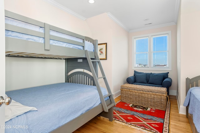 bedroom featuring light hardwood / wood-style floors and ornamental molding