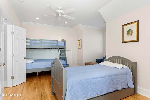 bedroom featuring ceiling fan, ornamental molding, and light hardwood / wood-style flooring