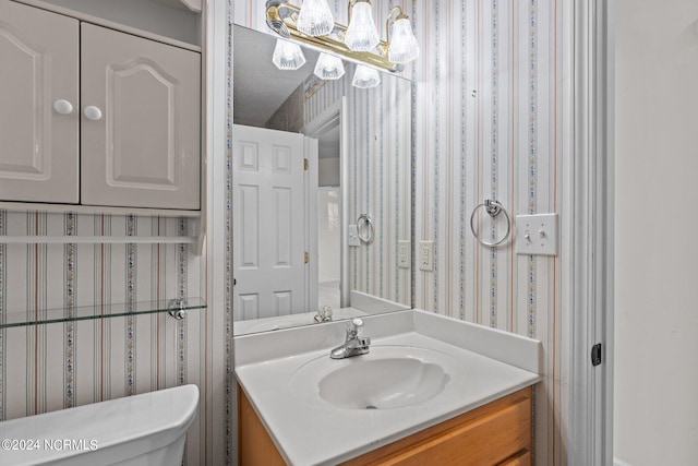 bathroom with toilet and vanity