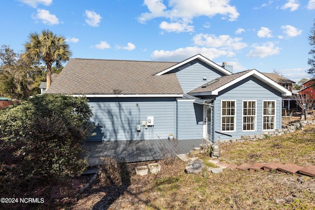 back of property with a wooden deck