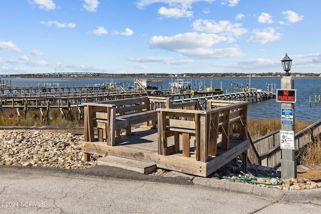 exterior space with a dock and a water view