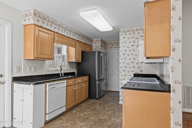 kitchen featuring tasteful backsplash, white appliances, dark tile floors, and sink