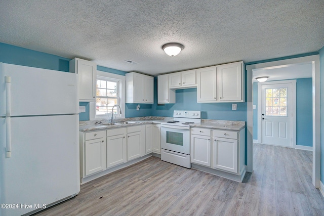 kitchen featuring white cabinetry, white appliances, and light hardwood / wood-style flooring