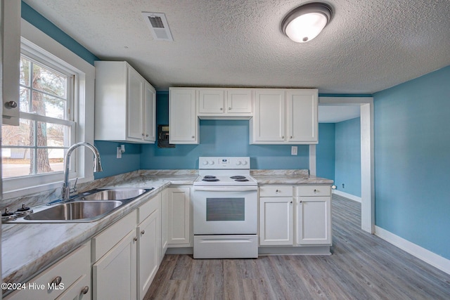 kitchen with sink, white cabinets, light wood-type flooring, and white electric stove