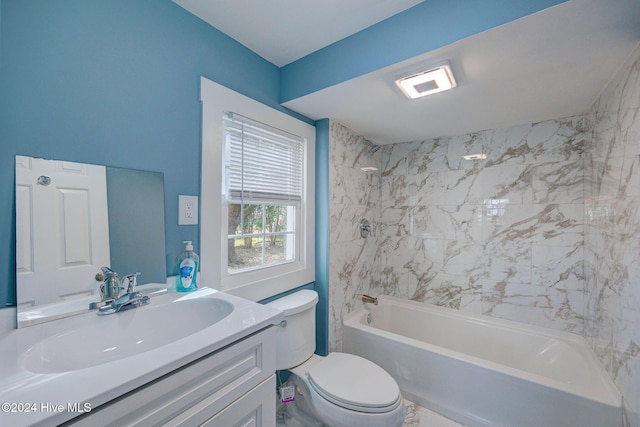 full bathroom with vanity, tiled shower / bath combo, and toilet