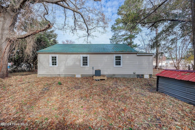 rear view of property featuring central air condition unit