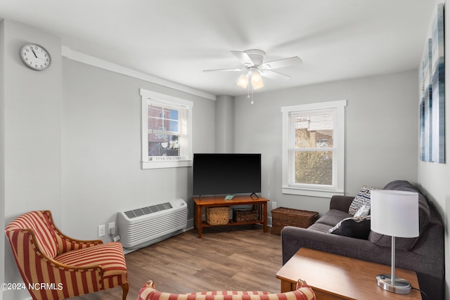 living room with ceiling fan and light hardwood / wood-style flooring