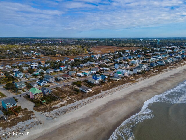 drone / aerial view with a water view and a beach view