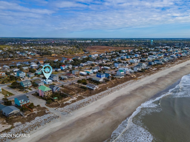 drone / aerial view featuring a view of the beach and a water view