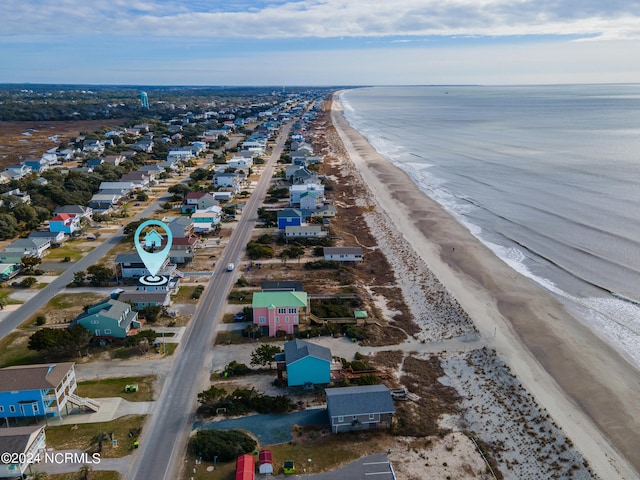 birds eye view of property with a view of the beach and a water view