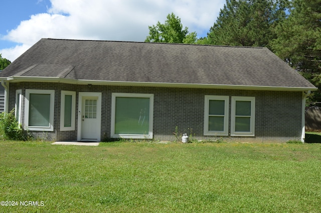 rear view of house with a yard