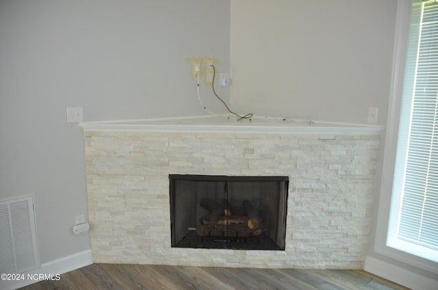 interior details featuring wood-type flooring and a fireplace