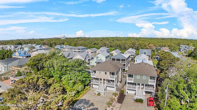 birds eye view of property featuring a forest view and a residential view