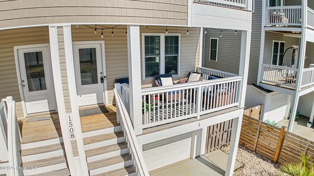 deck featuring covered porch and an attached garage