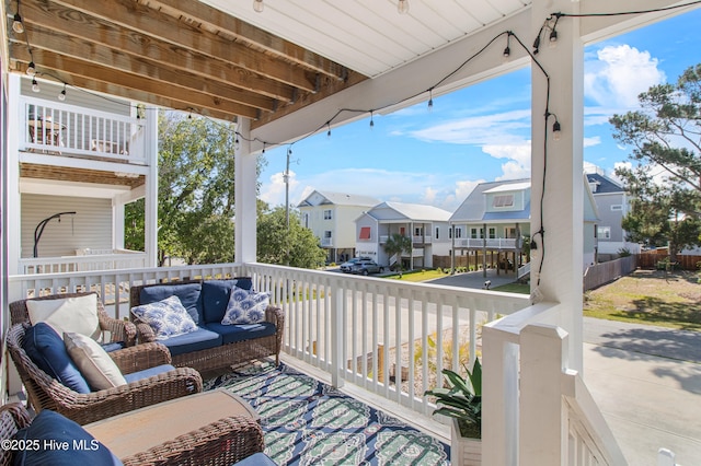 balcony with an outdoor hangout area and a residential view