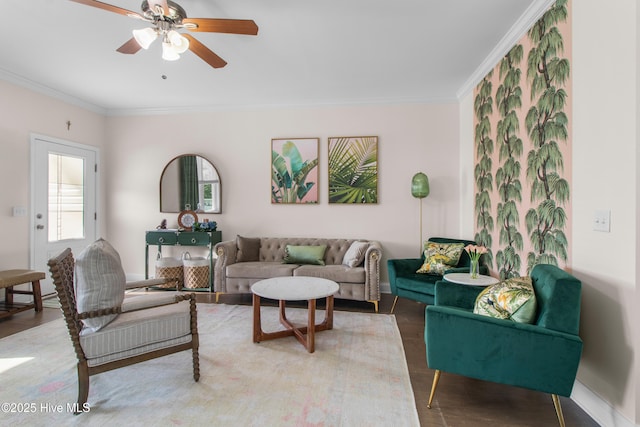 living room featuring crown molding, baseboards, ceiling fan, and light wood-style flooring