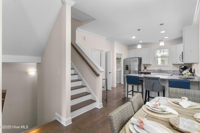 interior space with crown molding, stairs, recessed lighting, washer / dryer, and dark wood-type flooring