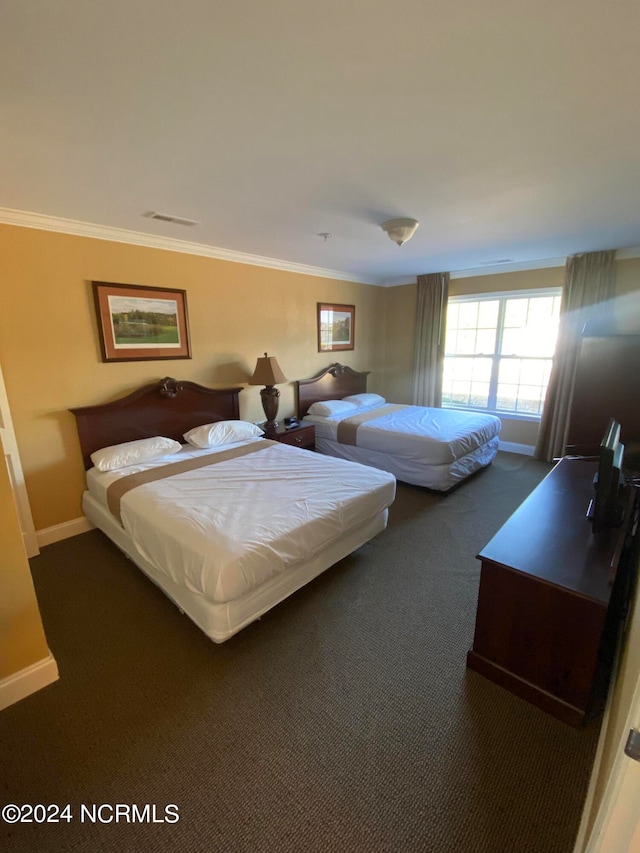 carpeted bedroom featuring crown molding