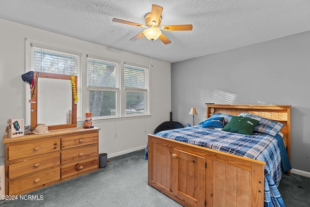 carpeted bedroom with ceiling fan and a textured ceiling