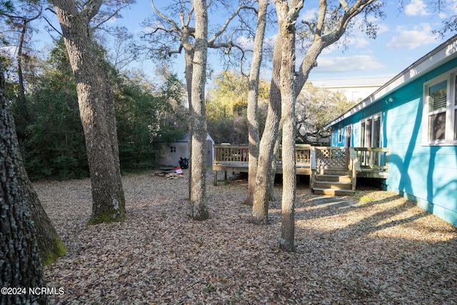 view of yard featuring a wooden deck