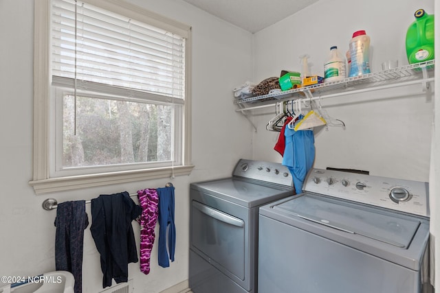 laundry area featuring washer and clothes dryer and a wealth of natural light