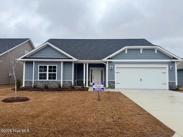 craftsman-style house featuring a garage and a front lawn