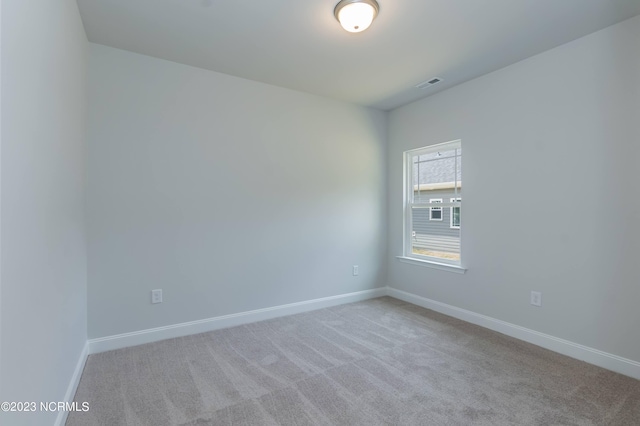 empty room featuring light colored carpet