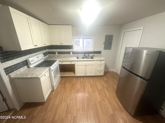 kitchen featuring sink, white electric range oven, white cabinets, light hardwood / wood-style floors, and stainless steel refrigerator