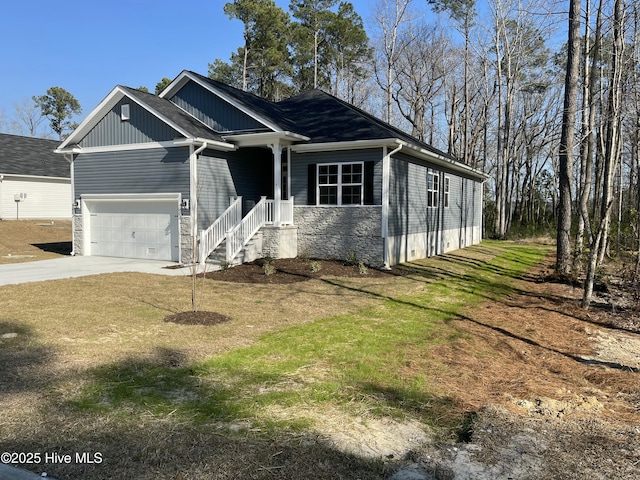 craftsman house featuring a garage, stone siding, a front lawn, and concrete driveway