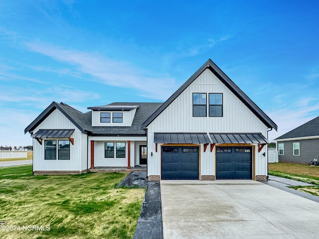 modern farmhouse with a front lawn and a garage