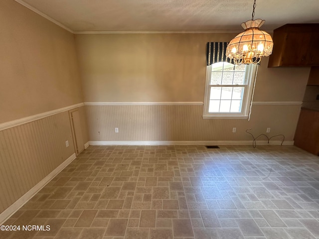 interior space featuring an inviting chandelier and crown molding