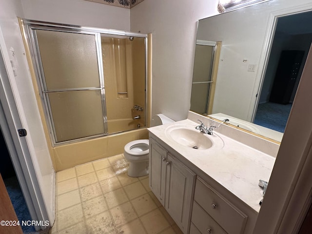 full bathroom with enclosed tub / shower combo, tile flooring, vanity, and toilet