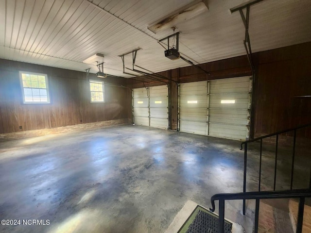 garage featuring wood walls and a garage door opener